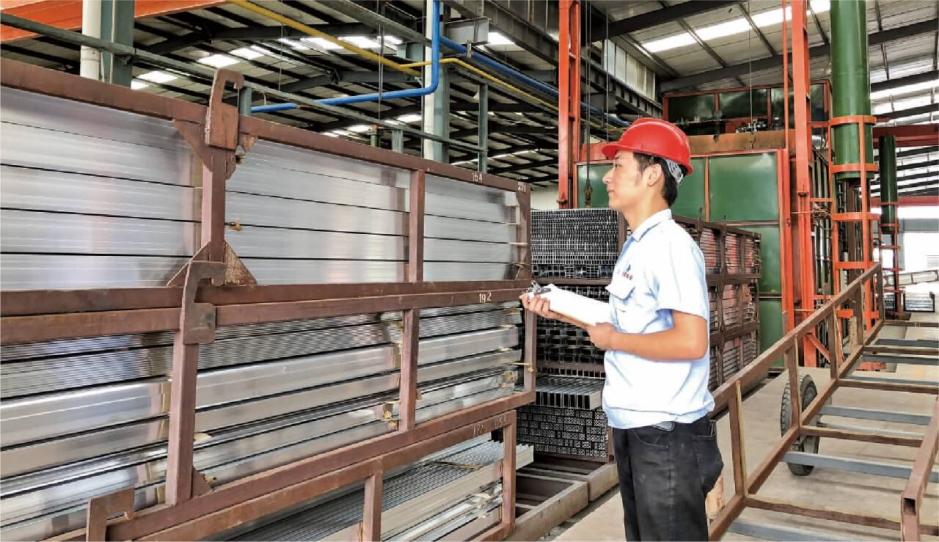 Operator checking the aluminum profile aging line